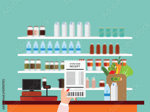Hand holding grocery shopping receipt.