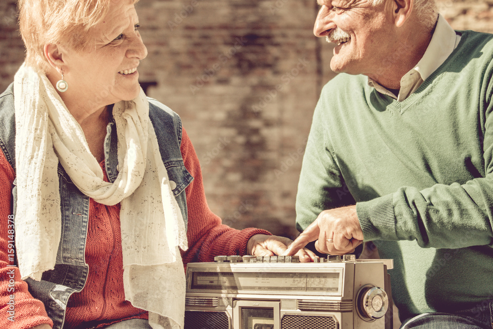 old couple happy retirement. elderly man and woman enjoy listening to  evergreen music on vintage radio Stock Photo | Adobe Stock