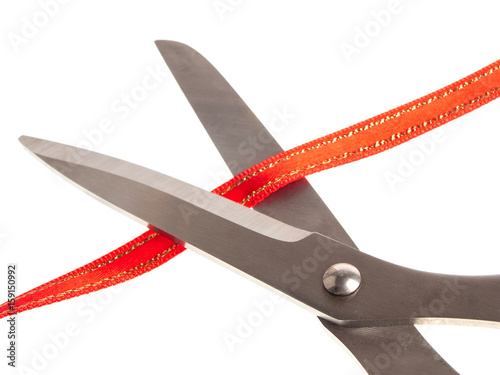 Pair of scissors  cutting red tape