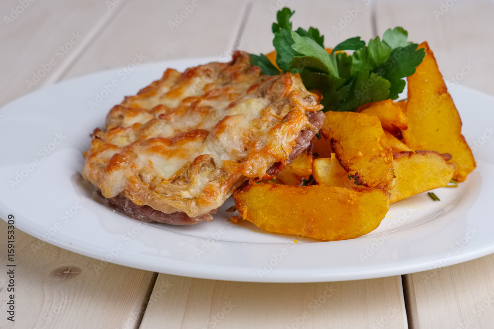 Close up view of plate with fried chopped meat and country style potato
