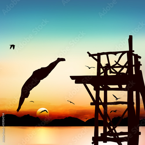 Silhouette and jumping man in the twilight with blue sky.