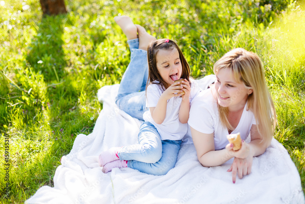 Happy mom and daughter. Walk in the green park Happy mom and daughter. Walk in the green park