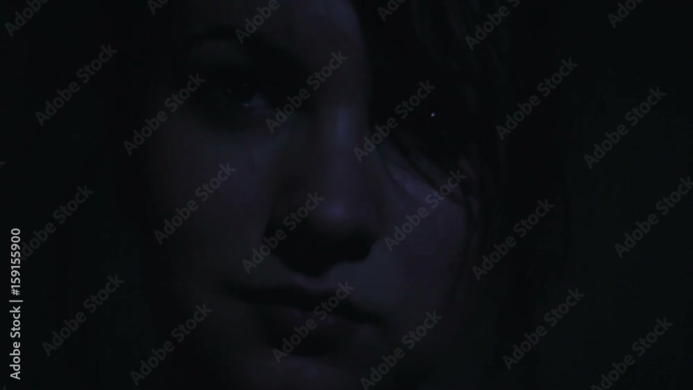 Face of a beautiful girl in the dark close-up Face of a beautiful girl in the dark close-up