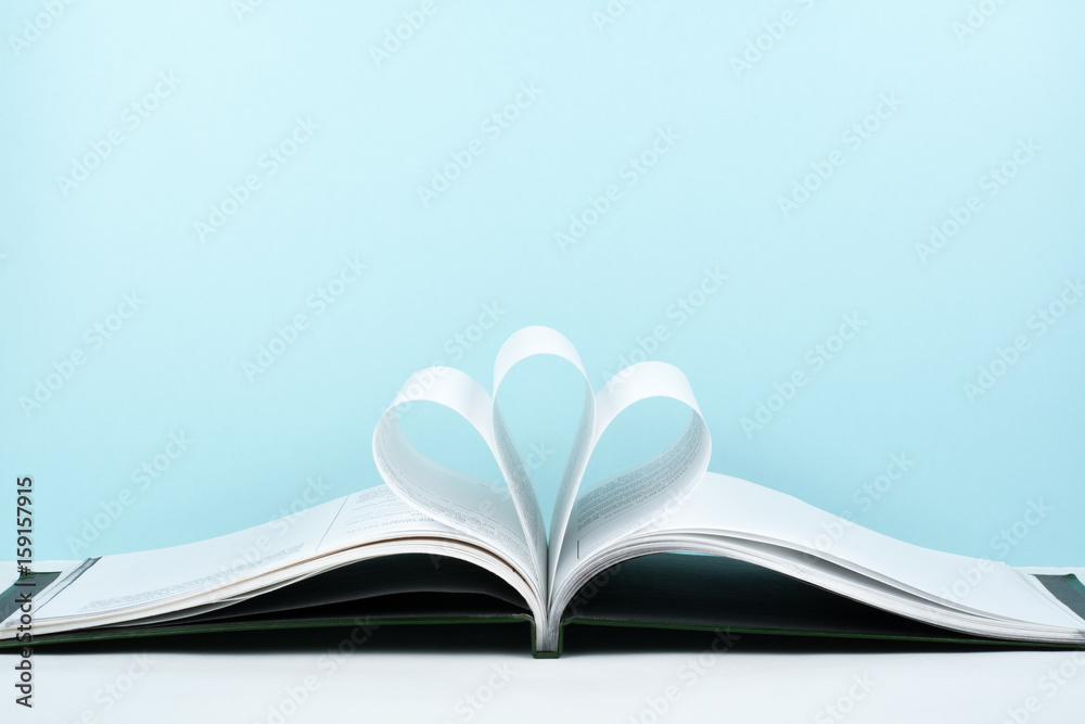 Old open hardback book, page decorate into a flower shape for love in Valentine's. love with open book heart. Old open hardback book, page decorate into a flower shape for love in Valentine's. love with open book heart.