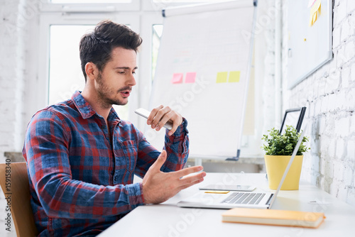 freelancer talking on phone discussing project with client