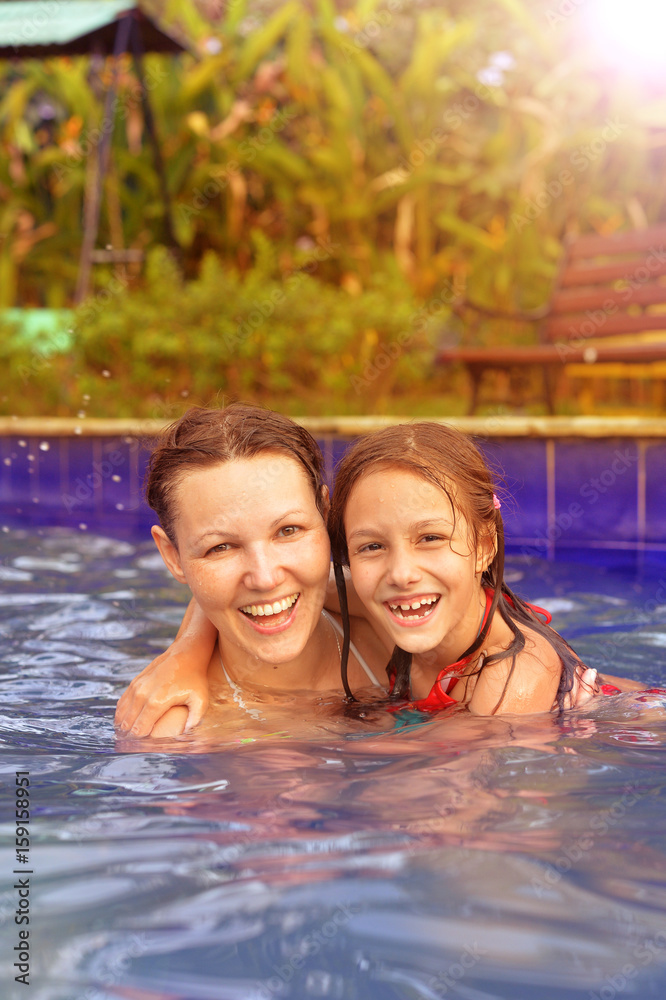 Mother and daughter in swimming pool Mother and daughter in swimming pool