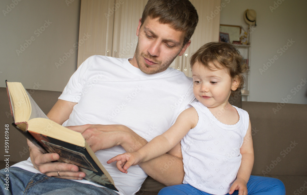 Obraz premium Dad is reading a book with a child. Young father. Father's Day