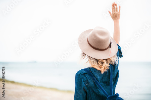 Summer portrait of young hipster woman in a brown hat having fun on the sea.young slim beautiful woman,bohemian outfit,indie style, summer vacation,sunny,having fun, positive mood,romantic
