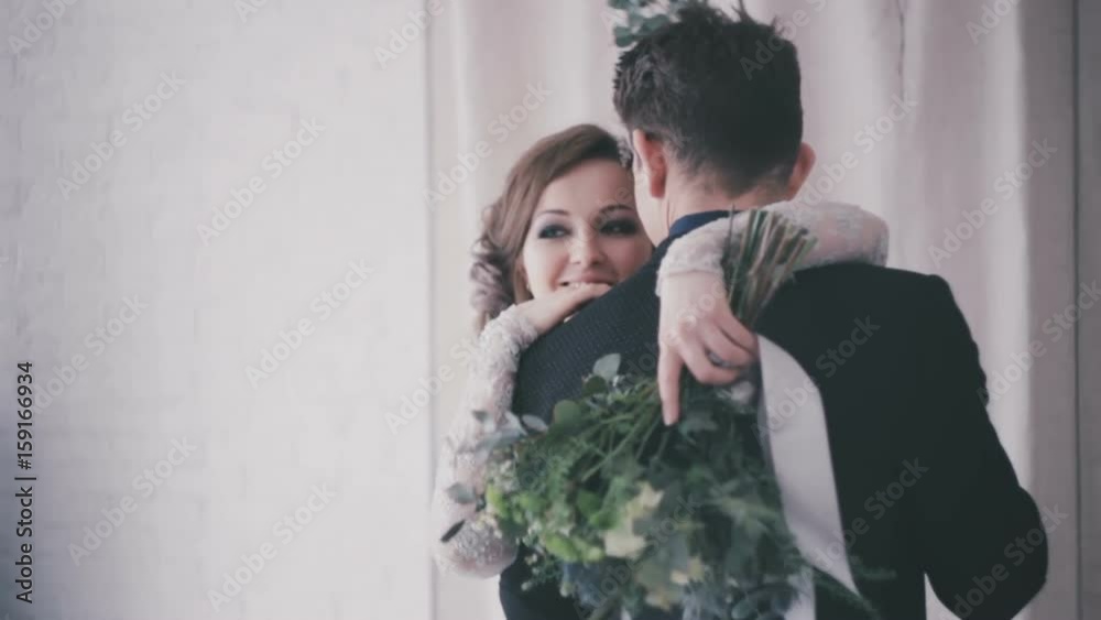 Beautiful bride and groom embrace close-up