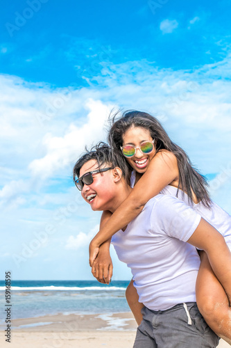 Asian couple having fun on the beach of tropical Bali island, Indonesia. © belart84