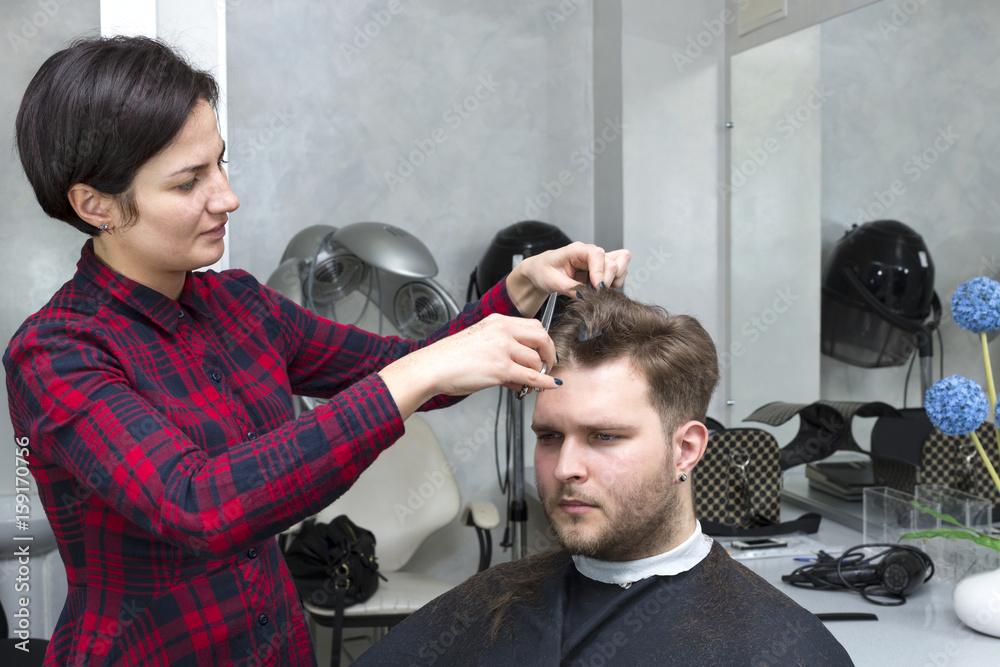 The young man at the hairdresser salon hairstyle make model The young man at the hairdresser salon hairstyle make model