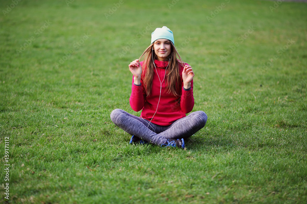 Smiling woman sitting in lotus on grass