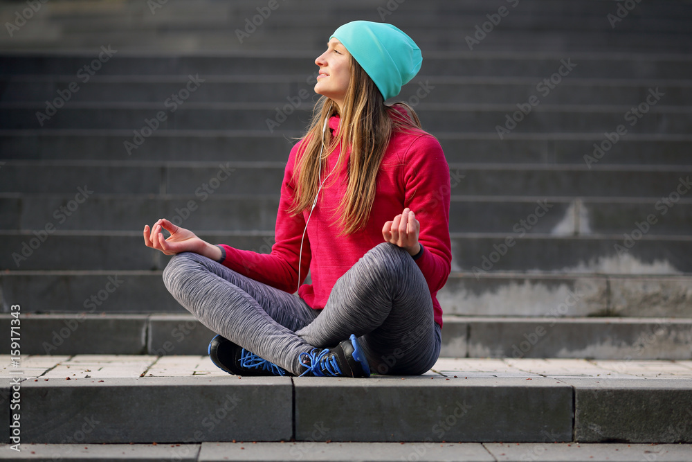 Meditating sports yoga woman on background of steps background Meditating sports yoga woman on background of steps background