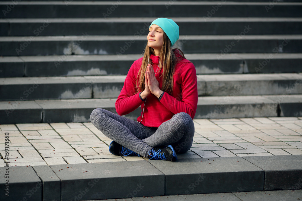 Meditating girl on urban background Meditating girl on urban background