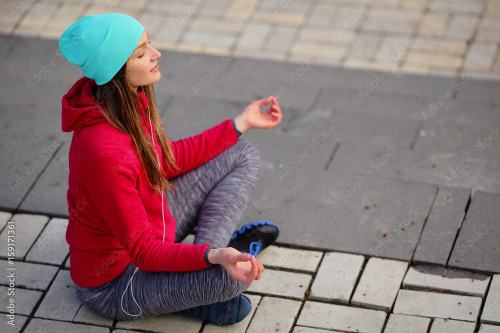 Yoga meditating woman in lotus, urban style, city park Yoga meditating woman in lotus, urban style, city park