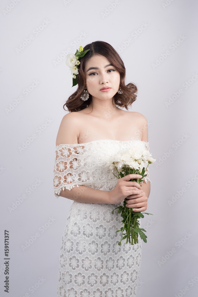 Beautiful asian woman bride on grey background. Closeup portraits with a professional makeup Beautiful asian woman bride on grey background. Closeup portraits with a professional makeup