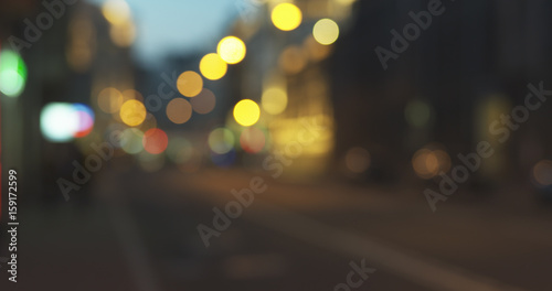 still blur background of night city with moving cars and walking people, wide photo