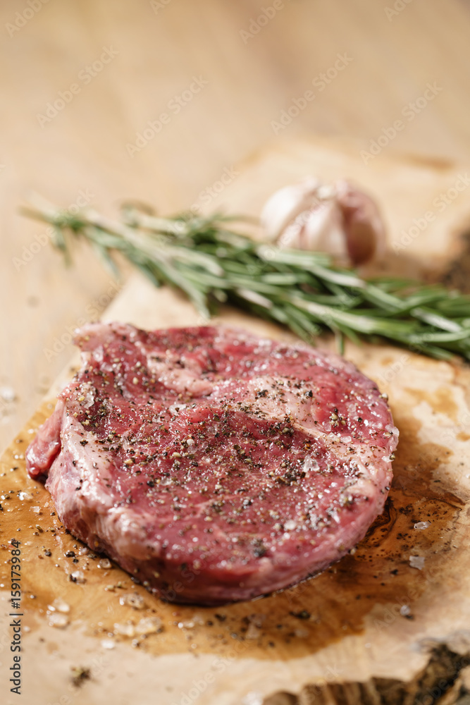 raw rib eye steak on board closeup, shallow focus raw rib eye steak on board closeup, shallow focus