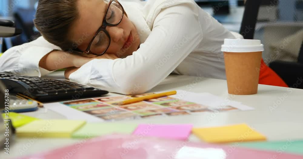 Female graphic designer sleeping at desk Female graphic designer sleeping at desk