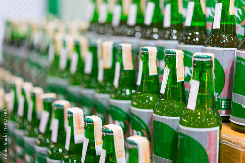 A bottle of green liqueur lined up on the shelves in the alcohols.