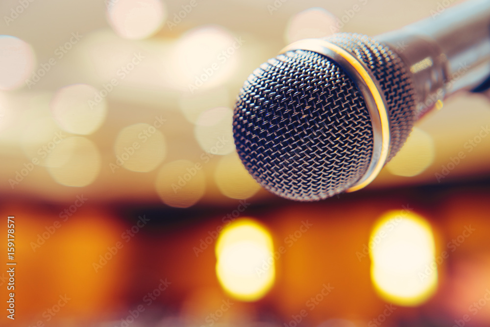 Microphone in the background with bright lights on the singing contest stage. Microphone in the background with bright lights on the singing contest stage.