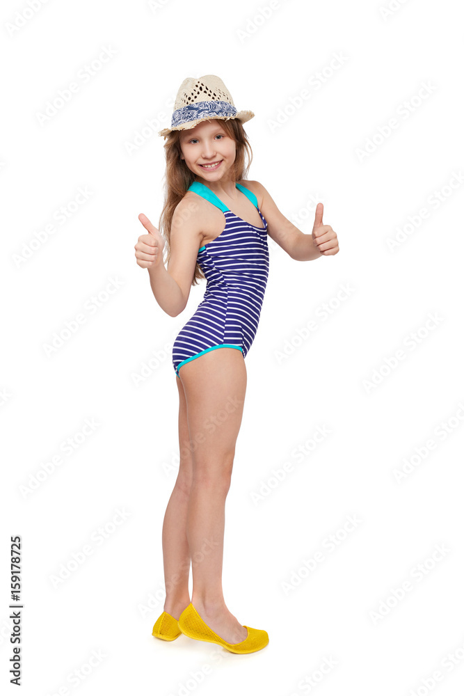 Full length child girl in swimsuit and summer hat giving double thumb up, over white background Full length child girl in swimsuit and summer hat giving double thumb up, over white background
