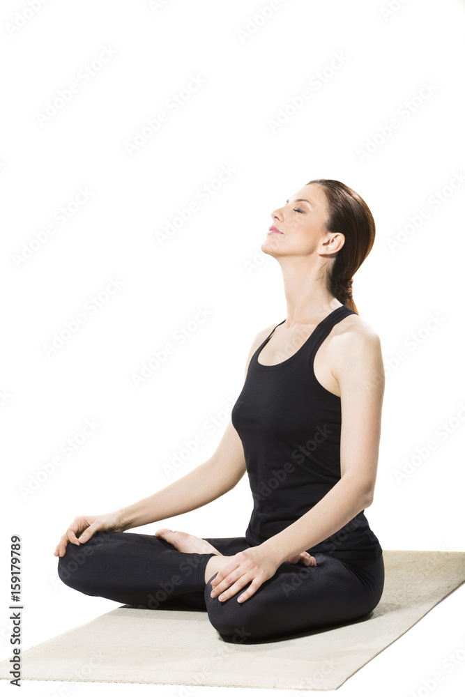 Beautiful woman in lotus position on yoga mat Beautiful woman in lotus position on yoga mat