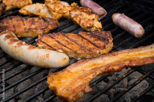 Close up of grilled sausages and steaks