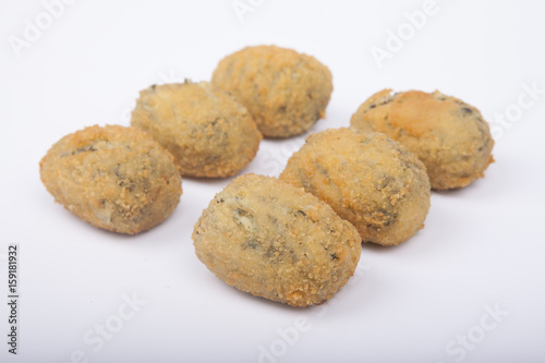 a handful of homemade croquettes of spinach isolated on white