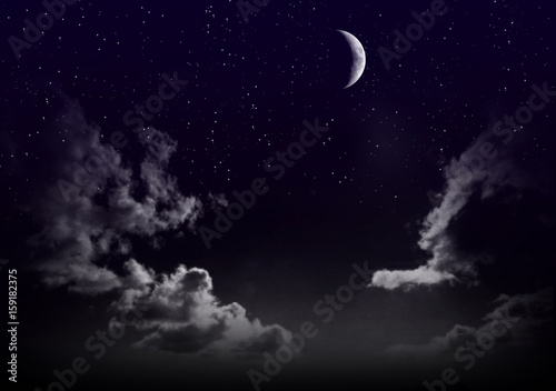 Beautiful magic blue sky with clouds and moon and stars at night closeup
