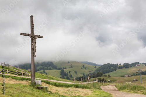 statue of Jesus on cross wooden background on natural view and fog
