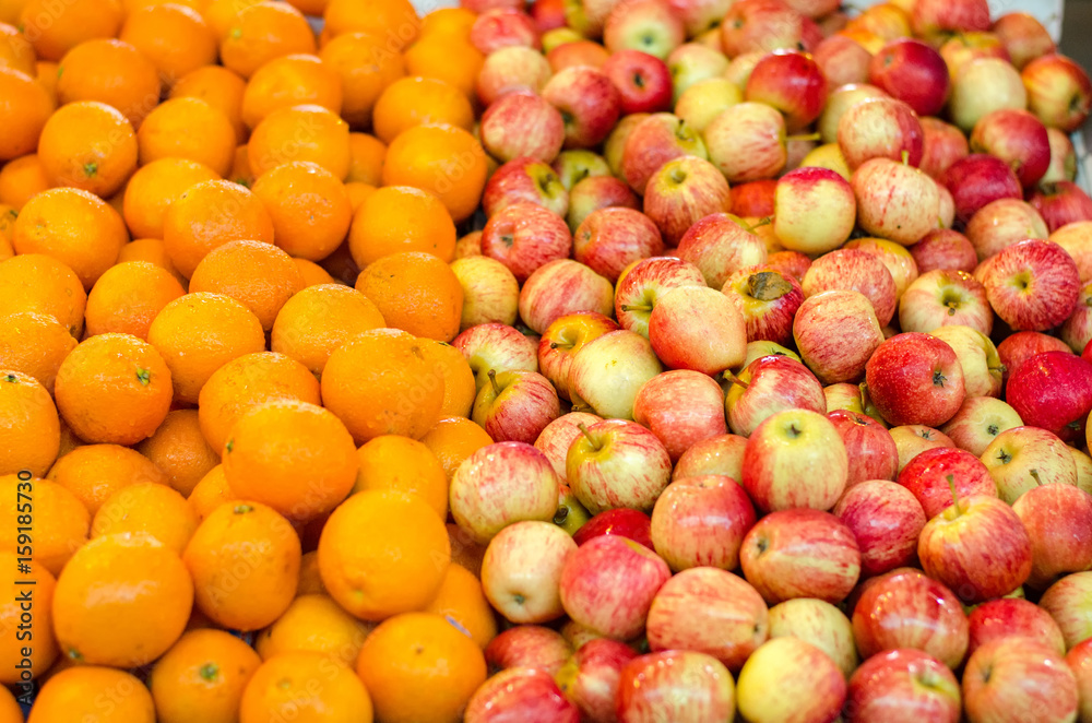 beautiful color combination, orange and red apple background display at market stall. selective focus shot