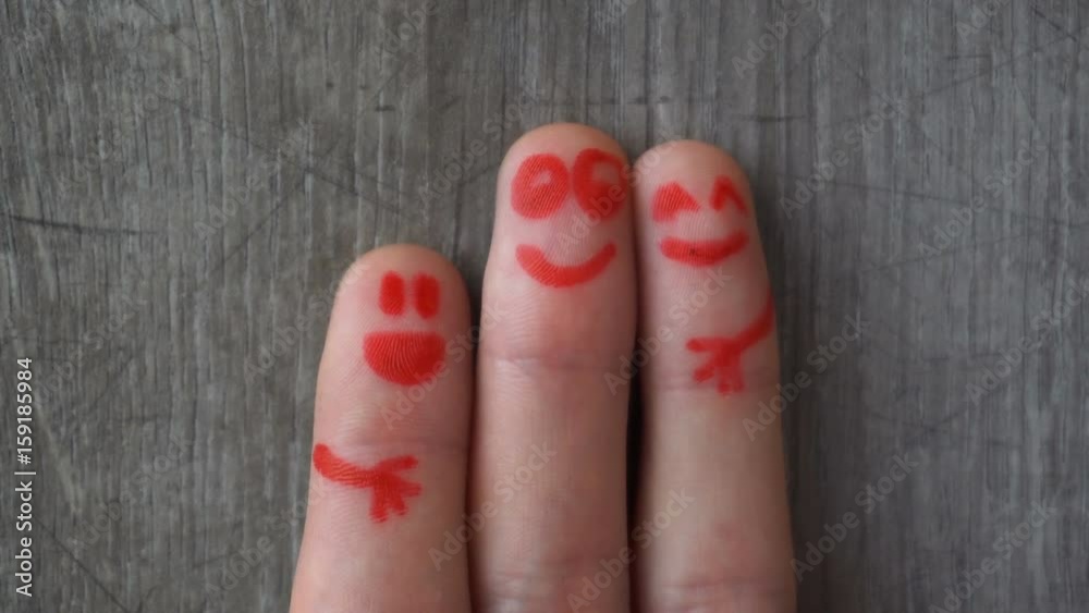 happy fingers.beautiful faces painted on the toes. happy fingers.beautiful faces painted on the toes.
