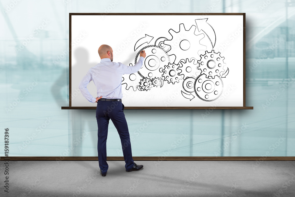 Businessman in front of a wall drawing ecology sketches - Nature concept Businessman in front of a wall drawing ecology sketches - Nature concept