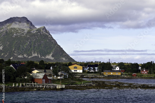 Boat dock, houses and mountains  in Risoyhamn, Norway photo