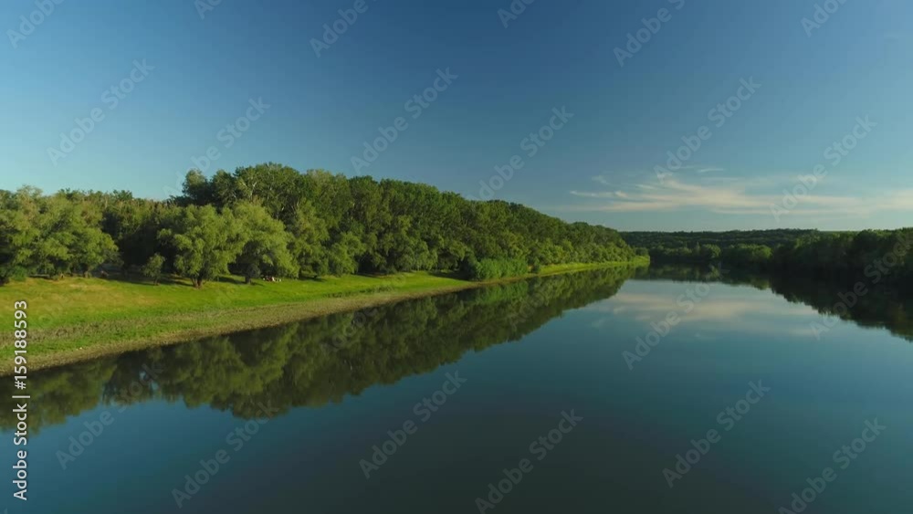 Aerial video of a quiet river and blue sky reflecting in it Aerial video of a quiet river and blue sky reflecting in it