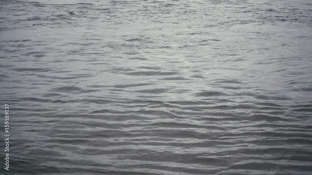 Slow mo. Shallow ripples on the water surface of a river or sea or lake Slow mo. Shallow ripples on the water surface of a river or sea or lake