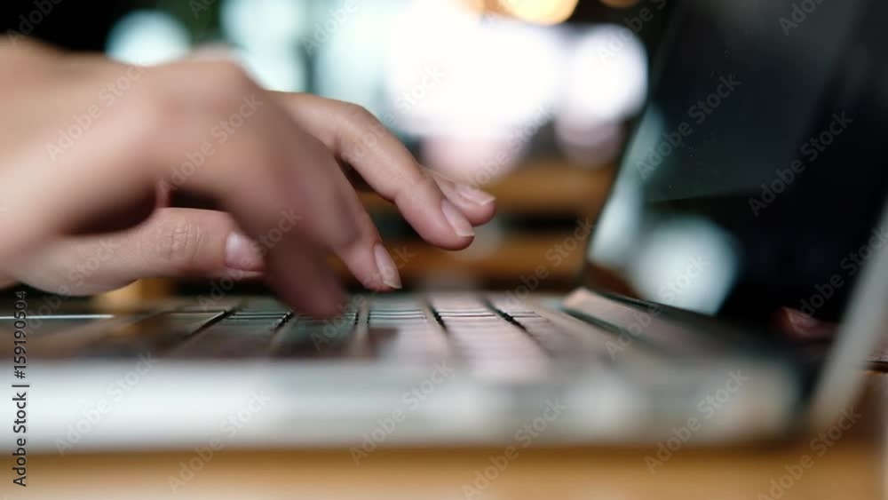 A business woman's hands working and typing on laptop keyboard A business woman's hands working and typing on laptop keyboard