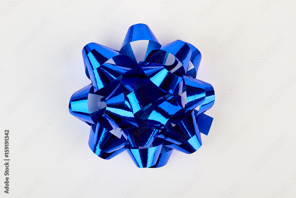 Blue bow for gift box. Bright bow on white, top view. Blue bow for gift box. Bright bow on white, top view.