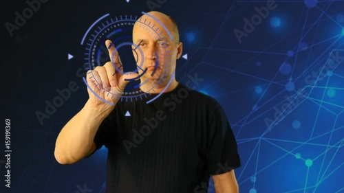 Adult man on futuristic background gestures virtual screen. Shureshki rotation. Gestures on touchscreen zoom touch swipe pinch. Sci-fi techno animation HUD GUI interface. Modern technology fituristic photo