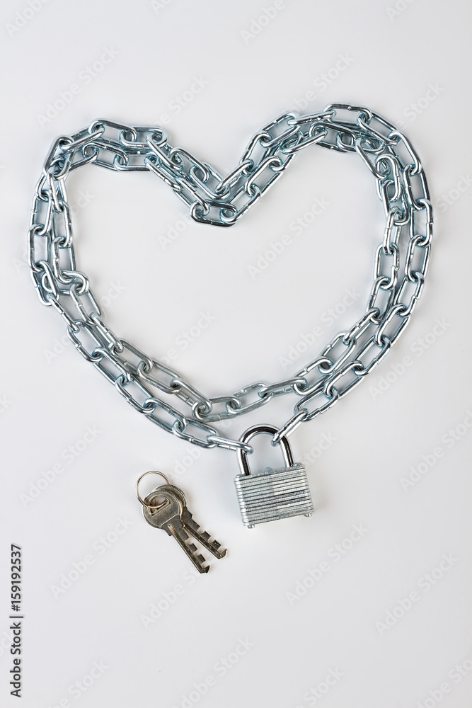 Chain in shape of heart. Lock, key, chain, white background. Concept of love safety. Chain in shape of heart. Lock, key, chain, white background. Concept of love safety.