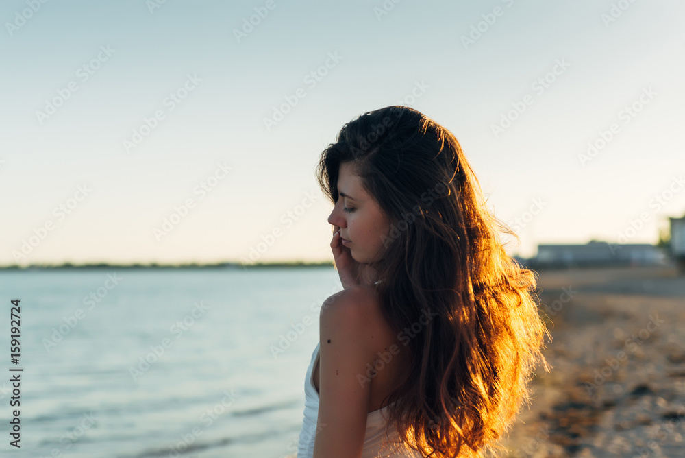 Portrait of a woman with long hair at sunset close-up Portrait of a woman with long hair at sunset close-up