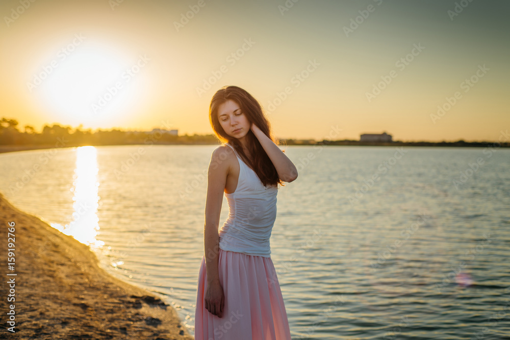 Portrait of a woman with long hair at sunset close-up