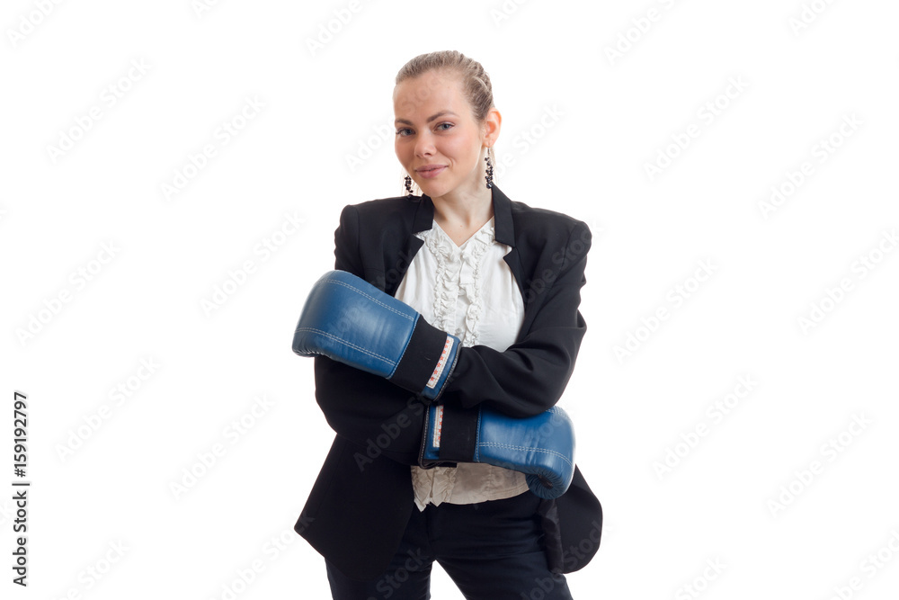 Beautiful blonde business woman in classic unifrom with blue boxing gloves smiling on camera Beautiful blonde business woman in classic unifrom with blue boxing gloves smiling on camera