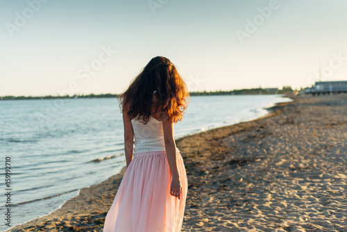 Woman with long hair at sunset