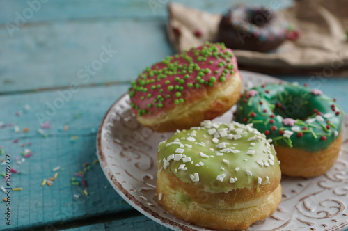 delicious homemade donuts on rustic turquoise wooden background. Delicious breakfast, selective focus