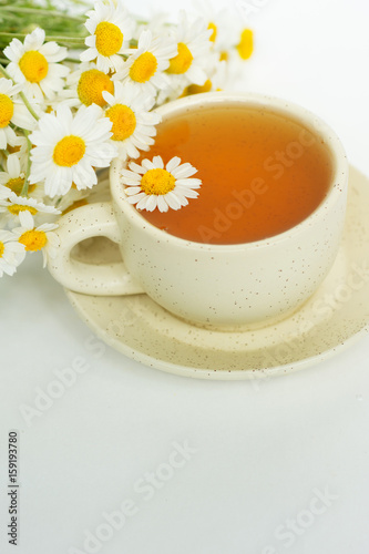 cup of herbal chamomile tea with camomile dry blossoms, dried camomile flowers. doctor treatment and prevention of immune concept, medicine - folk, alternative, complementary, traditional medicine