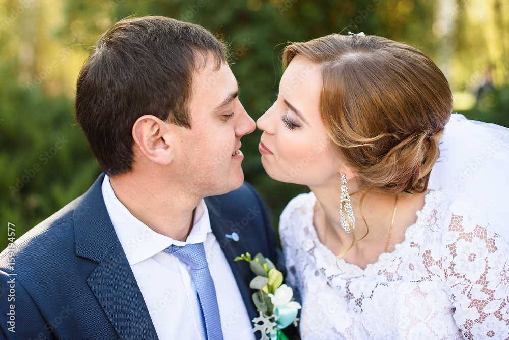 happy bride and groom at a park on their wedding day happy bride and groom at a park on their wedding day