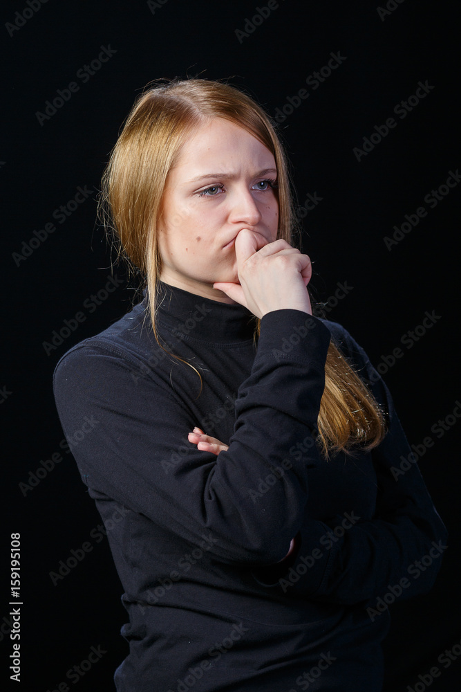 Young blond woman on black background Young blond woman on black background
