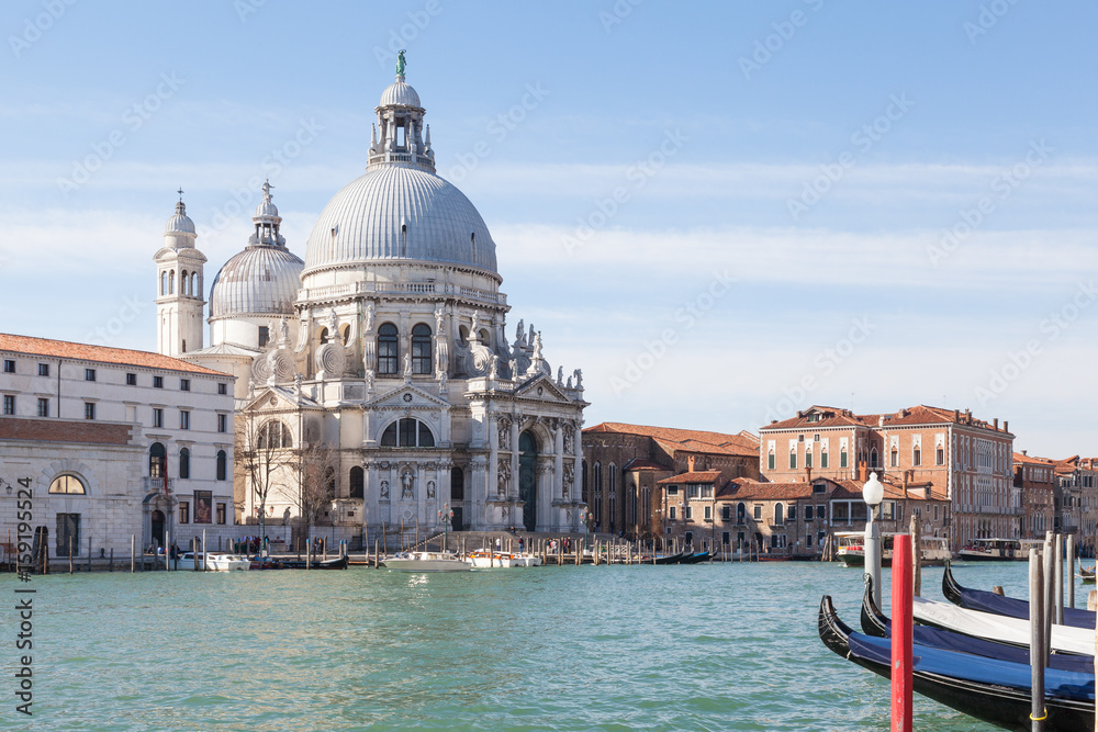 Obraz premium Venice, Veneto, Italy. View of Basilica di Santa Maria della Salute, Dorsoduro, in morning light across the Grand Canal with moored gondolas 